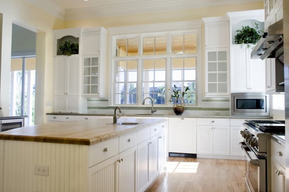 Beautiful light kitchen with white cabinets and beadboard detail!