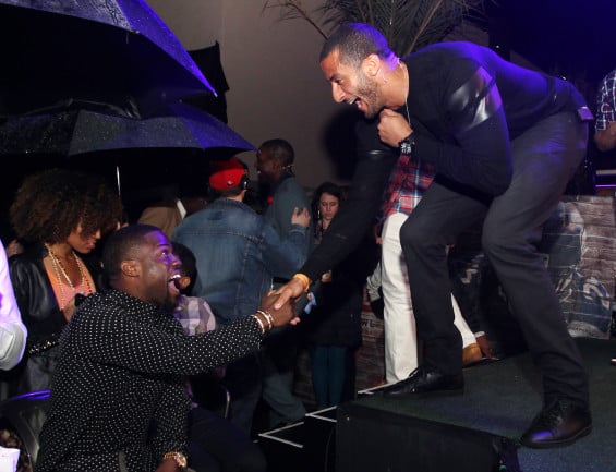 Kevin Hart smiles while shaking hands with 49ers quarterback Colin Kaepernick seen at EA SPORTS Madden Bowl 2015 Thursday, Jan., 29, 2015, in Phoenix. (Photo by Donald Traill/Invision for EA SPORTS/AP Images)