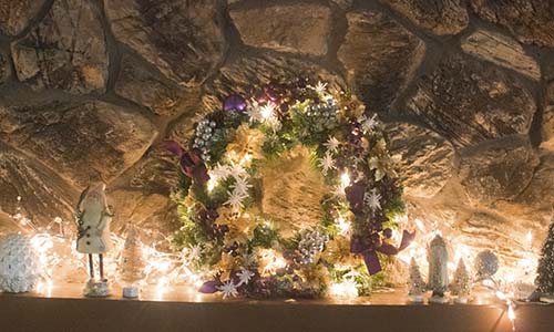 I love decorating my mantel with Christmas lights and my purple and gold lit wreath!