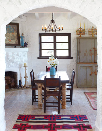 The dining room's antique table is a charming mix of birch and pine. The floor is reclaimed wood treated with Old Masters Gel Stain in Pickling White. Painted armoire from Nathan Turner. Read more: Spanish Style Homes - Country House Decorating - House Beautiful 