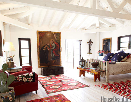 Master Bedroom Religious art, stars and stripes, and Navajo rugs are surprisingly harmonious in the master bedroom. The bed was made from an old picket fence. Paintings and trunk from Mediterranee Antiques. Flag pillows by Laurel Adams Design. Rugs from Ranchfolks. Read more: Spanish Style Homes - Country House Decorating - House Beautiful 
