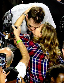 Super Bowl MVP Tom Brady of the New England Patriots kisses his wife Gisele Bundchen (in a red and blue Rails plaid top) after defeating the Seattle Seahawks. Credit: Jamie Squire/Getty Images Image courtesy of US Magazine.