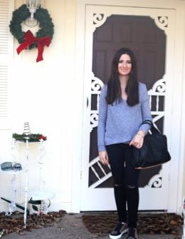 Candace Rose Anderson Lanston asymmetrical crossover top (grey), black distressed AG jeans (similar), Burberry studded sneakers and Alexander Wang Rocco bag in black with rosegold studs (similar).