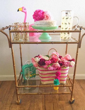 Lifestyle blogger Candace Rose Anderson of the blog Candie Anderson adorned her gold faux bamboo bar cart with flamingo decor must haves, garden roses, and a straw tote for summer!