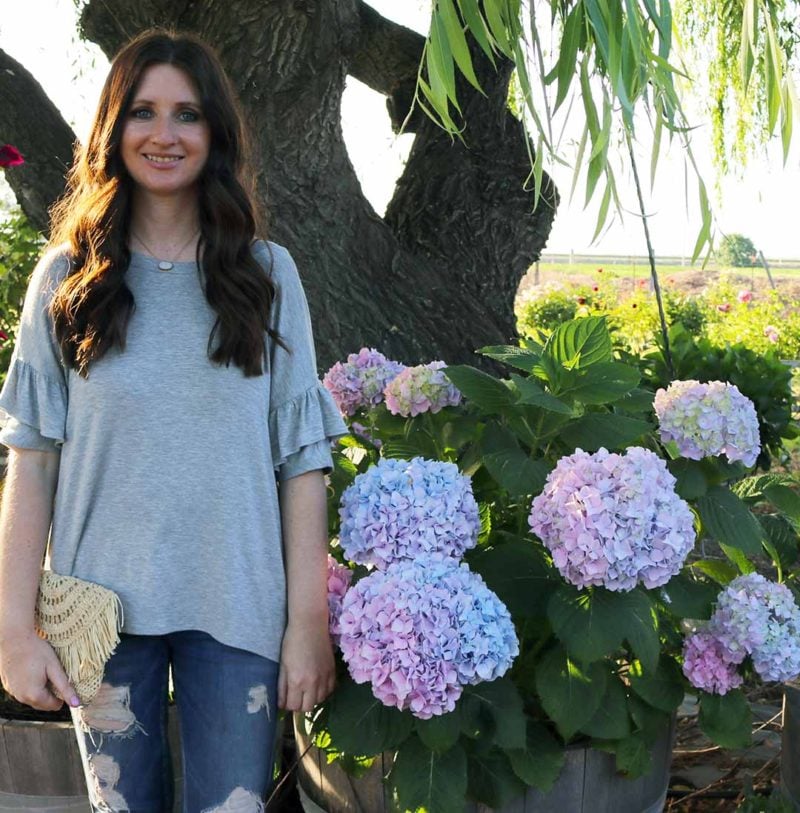 lifestyle and fashion blogger candace rose loves her ruffle sleeve top crown jewelry druzy necklace straw bag for summer