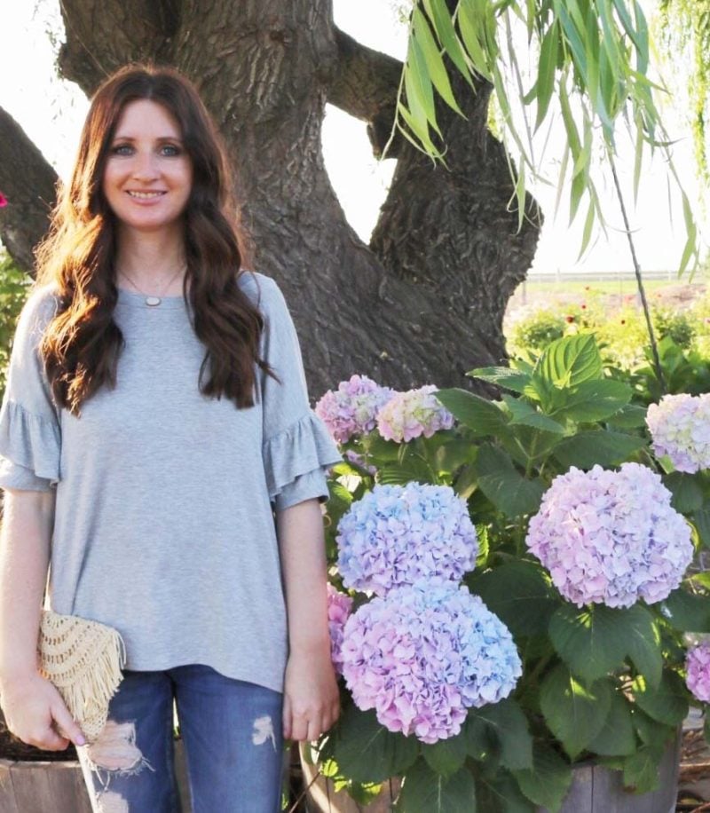 fashion blogger candace rose anderson of the blog candieanderson.com loves her ruffle sleeve top and crown jewelry white druzy necklace