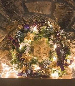 I love decorating my mantel with Christmas lights and my purple and gold lit wreath!