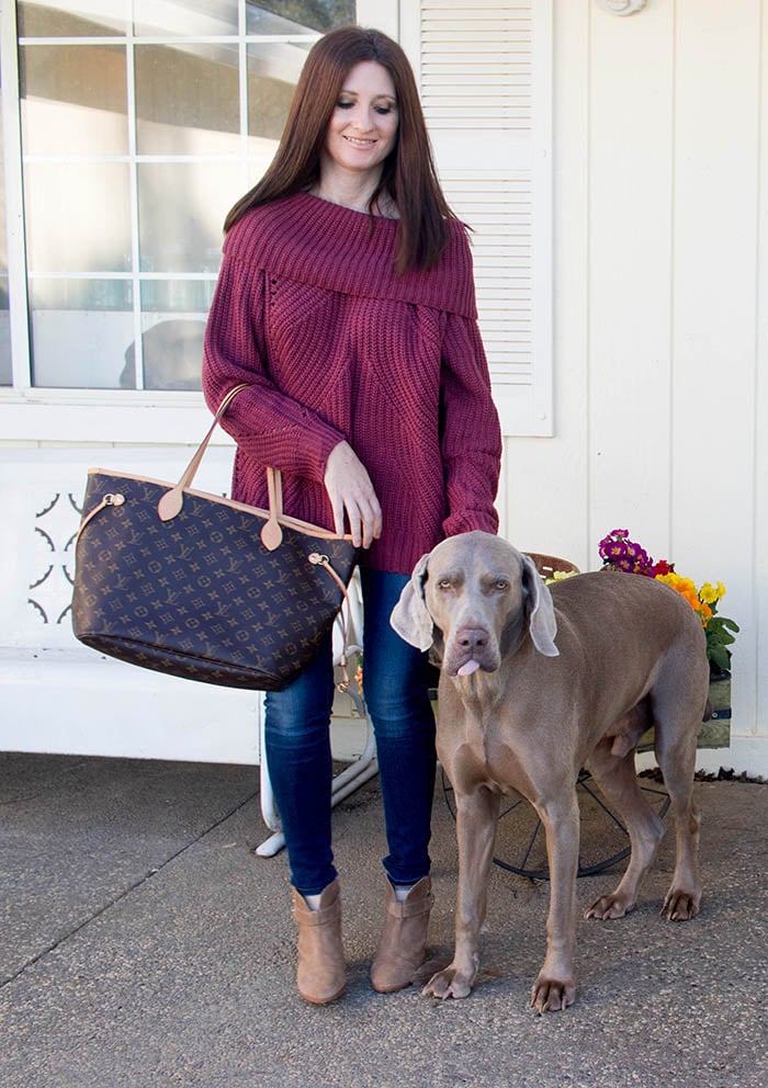 Candace Anderson poses with her Weimaraner Fred who is sticking his tongue out at the camera.