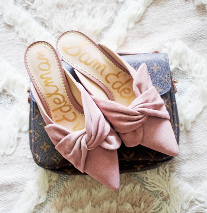 Style expert and blogger shares the top shoes for spring including these beautiful blush pink mules atop a Louis Vuitton Pochette Metis bag.