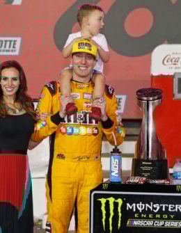 "Kyle Busch, driver of the #18 M&M's Red White & Blue Toyota, poses with the trophy, his wife, Samantha, and son, Brexton, after winning the Monster Energy NASCAR Cup Series Coca-Cola 600 at Charlotte Motor Speedway on May 27, 2018 in Charlotte, North Carolina.