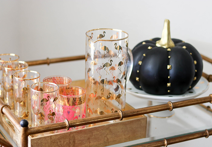 Candie Anderson of Candieanderson.com shares her flamingo highball glasses, pitcher, black studded pumpkin and white cake plate for fall.