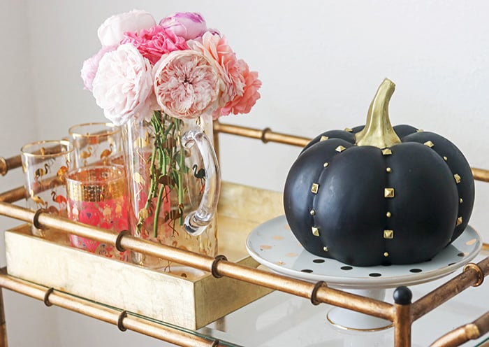 Candie Anderson filled her fall bar cart with gorgeous garden roses from her flower farm rosecandi, a fun black and gold studded pumpkin and trendy flamingo glassware
