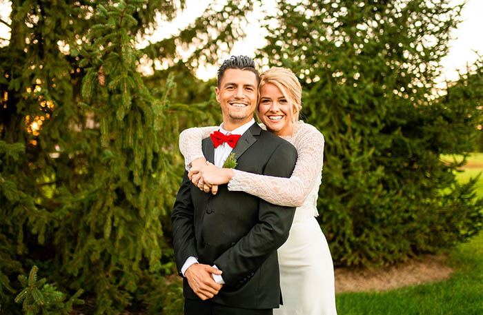 bride and groom smiling at wedding. she's wearing a build-a-bride wedding dress.