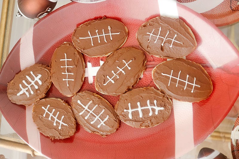 Lifestyle expert, foodie, blogger and sports fan Candie Anderson has the scoop on how she created these cute football shaped sugar cookies which she frosted with chocolate and white frosting. 