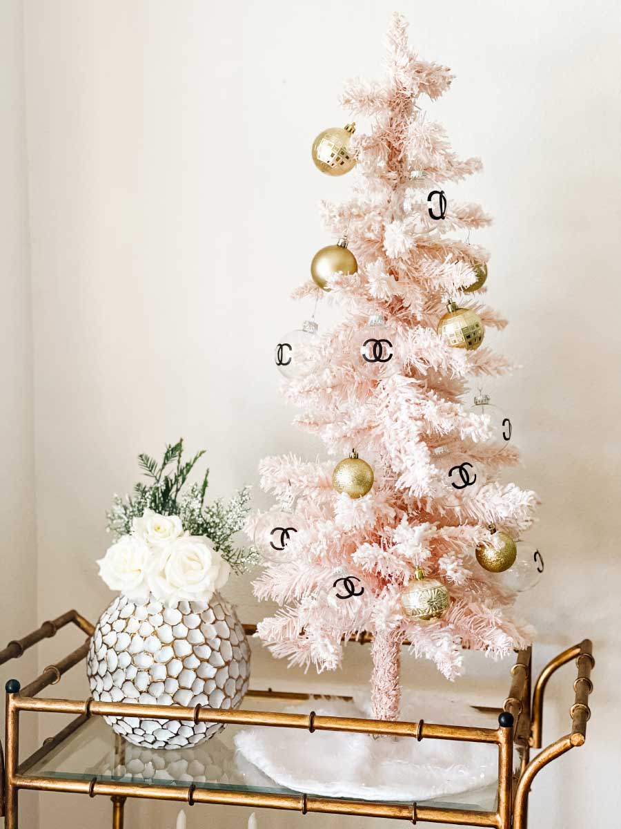 Lifestyle expert, journalist and interior design blogger Candie Anderson shares her tabletop flocked pink Christmas tree decorated for the holidays.