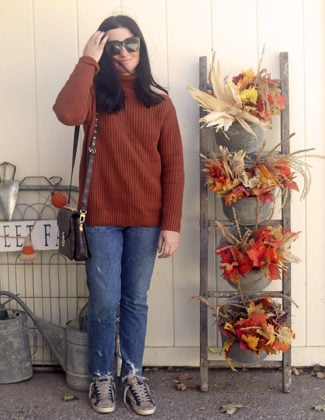 Candie Anderson wearing an ASTR the Label Sepulveda cutout shoulder sweater, Louis Vuitton Pochette Metis handbag, denim jeans, Golden Goose sneakers and black sunglasses.