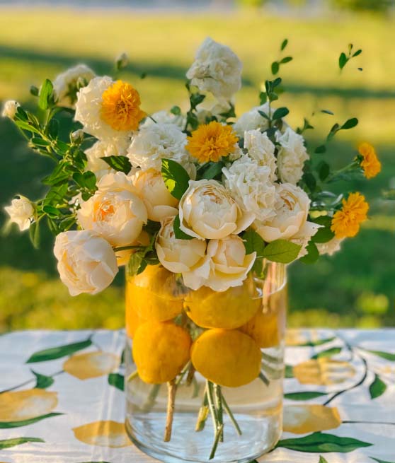 Lifestyle expert, journalist and interior design blogger Candie Anderson of candieanderson.com shares her gorgeous wide mouth cylinder vase from Walmart which she filled with yellow, white garden roses, boxwood and real lemons!