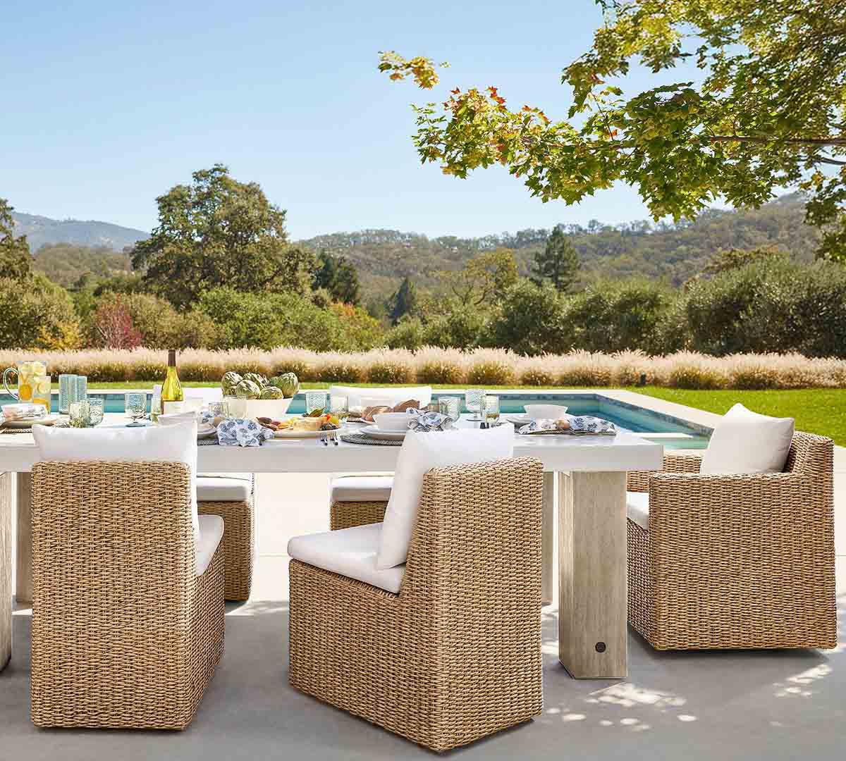 Pottery Barn Kostas Wicker Swivel Outdoor Dining Armchair best outdoor wicker dining chairs tablescape