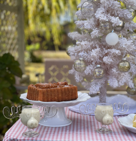 Lifestyle expert, journalist and entertaining blogger Candie Anderson of candieanderson.com shares her holiday tablescape which includes a gorgeous loaf cake, Marty moose mugs, a gorgeous flocked pink Christmas tree and gorgeous and affordable shatterproof round white, yellow gold and champagne gold ornaments.