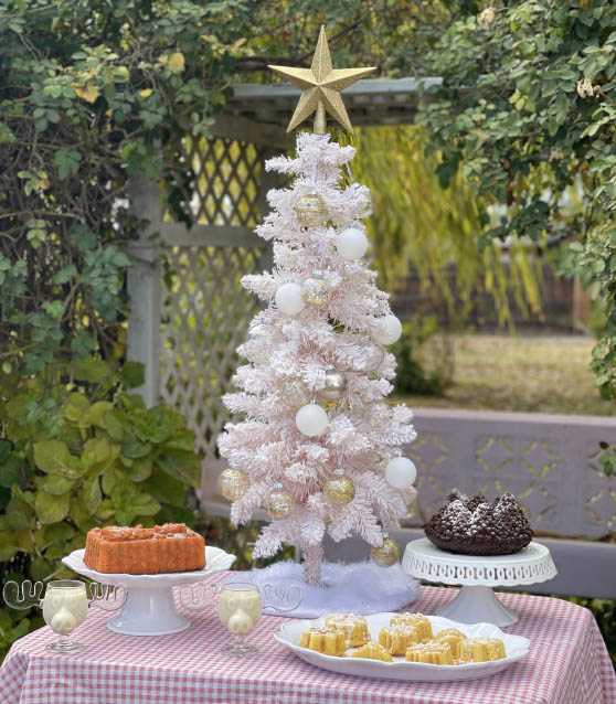 Lifestyle expert, journalist and interior design blogger Candie Anderson shares her holiday entertaining and decor essentials including a white mini faux fur Christmas tree skirt under her pink flocked tabletop tree.