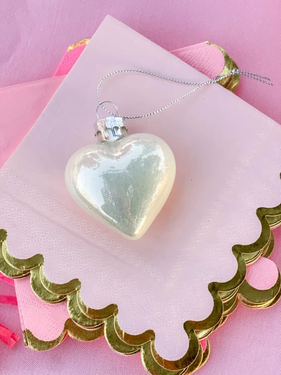 Lifestyle expert, journalist and entertaining blogger Candie Anderson shares her beautiful Lillian Vernon shiny glass heart shaped ornaments on her Valentine's Day party tablescape. They look great paired with her pink and gold cocktail napkins.