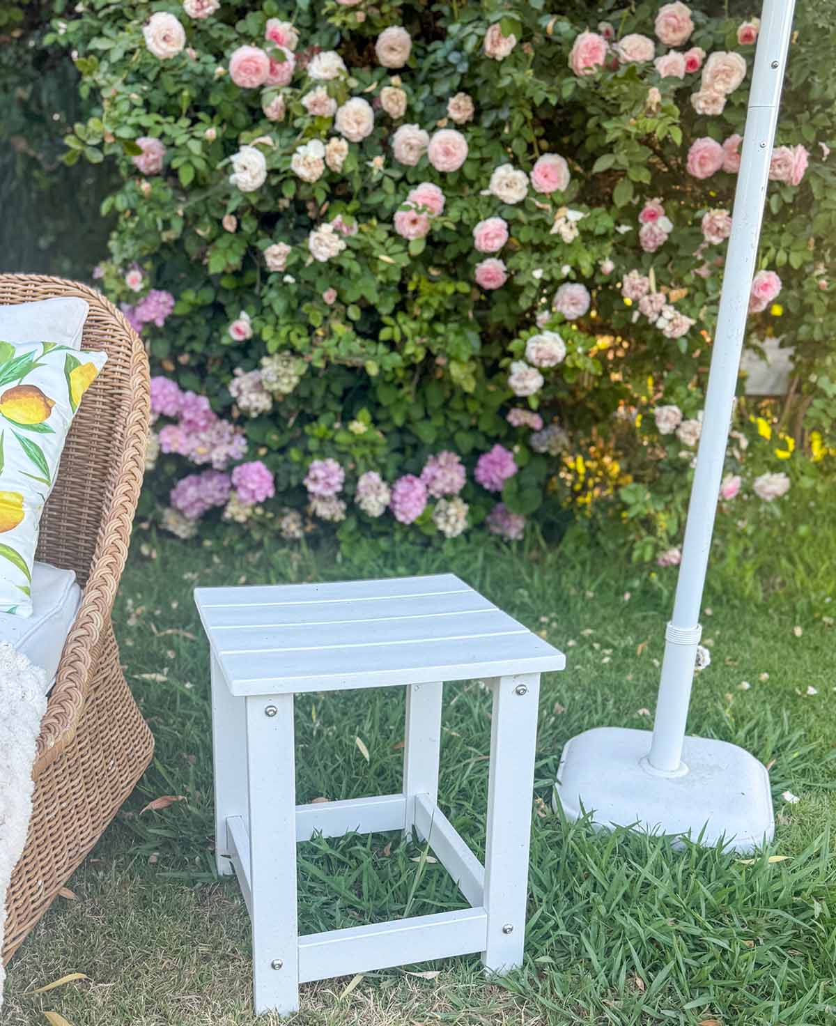 Ebern Designs Denarrius Outdoor Side Table on Candie Anderson's lawn for her outdoor lemon summer theme party.