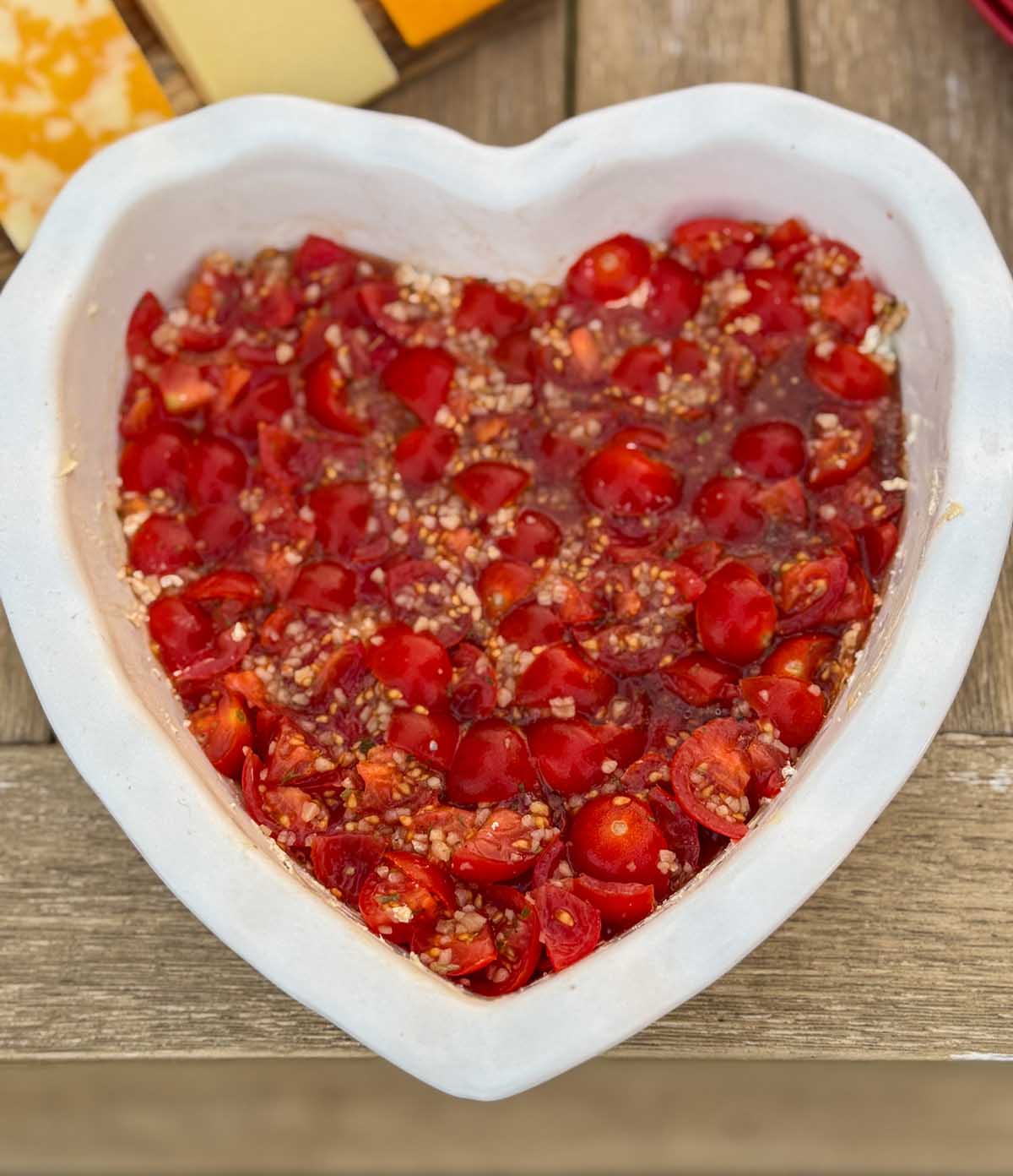 Entertaining expert, journalist and lifestyle blogger Candie Anderson of candieanderson.com shares her delicious bruschetta dip in a heart shaped dish. She served this for Valentine's Day. It's also perfect for Galentine's Day!