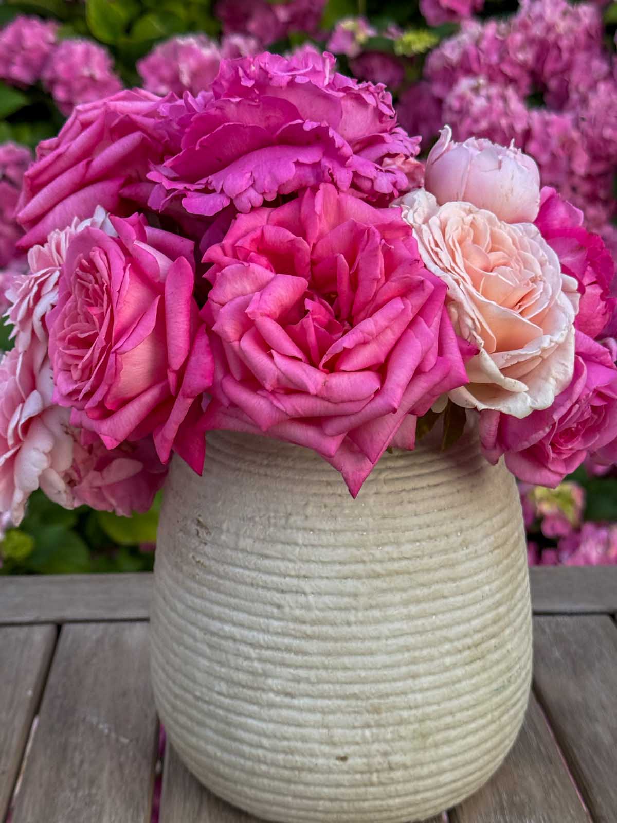 Entertaining expert, journalist and lifestyle blogger Candie Anderson of candieanderson.com shares her gorgeous pink roses in a ceramic vase. They look gorgeous on her outdoor entertaining station.