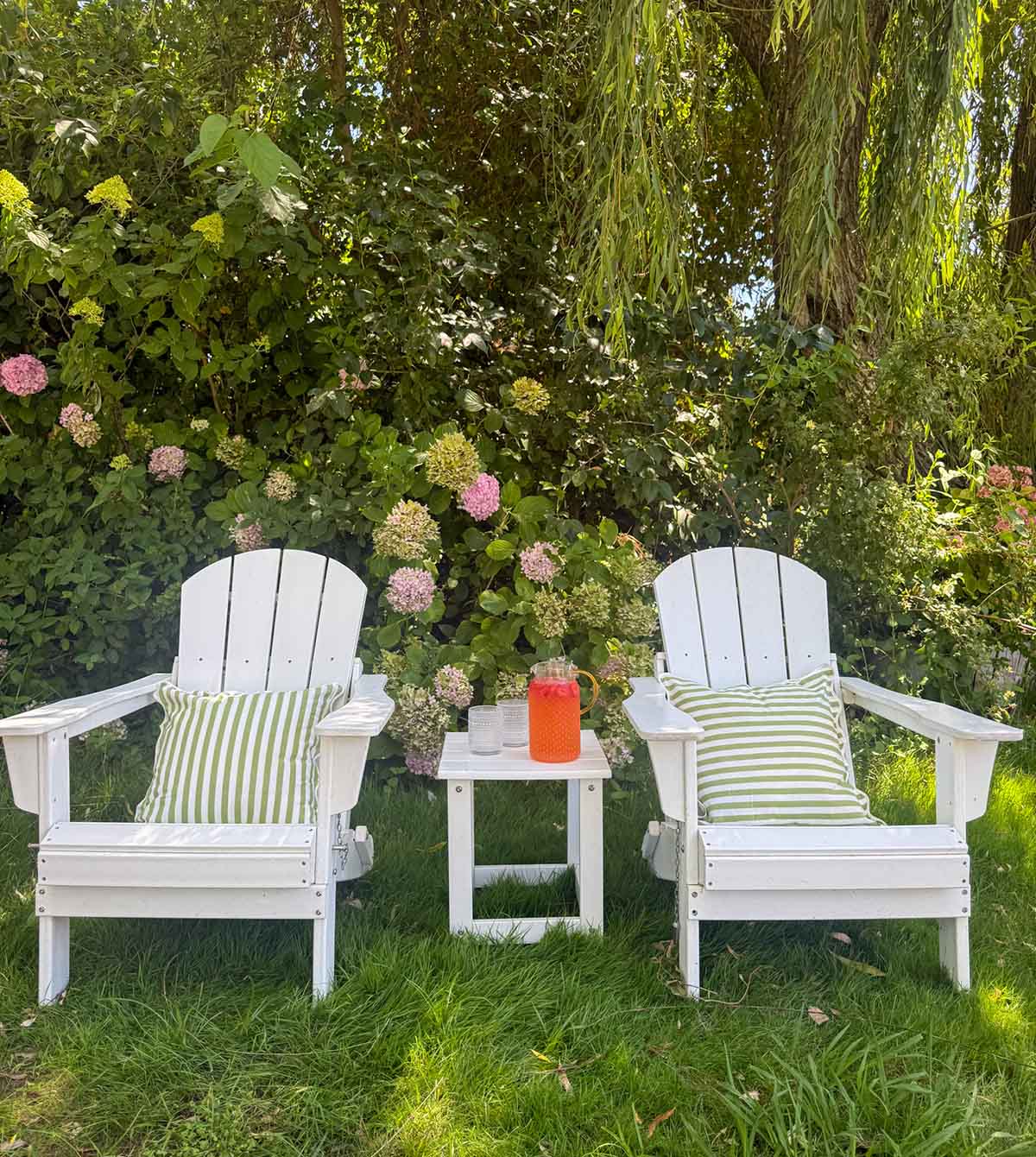 Lifestyle expert, journalist and interior design blogger, Candie Anderson of candieanderson.com shares the Wade Logan Laguna Adirondack Set in white in her hydrangea garden. If you're searching for classic outdoor seating essentials for summer, you will love these chairs!
