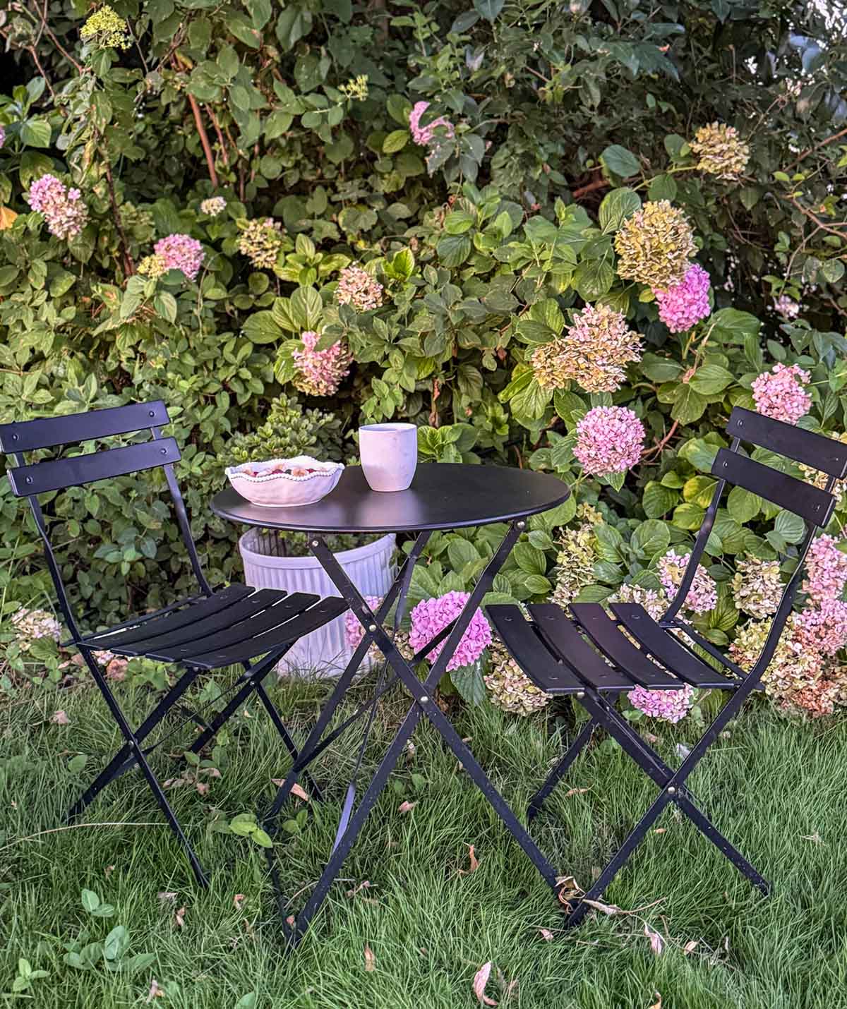 Lifestyle expert, journalist and interior design blogger Candie Anderson of candieanderson.com shares her black bistro set in her hydrangea garden. It is perfect for breakfast, lunch, dinner and dessert.