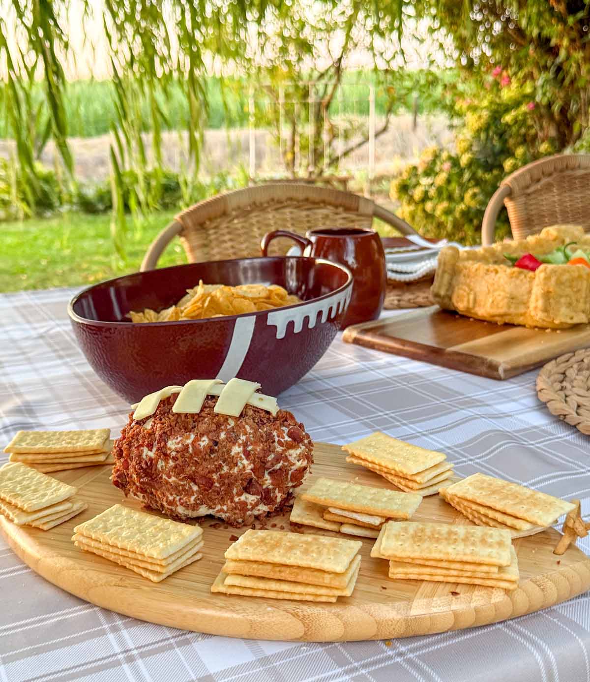 Entertaining expert, journalist and lifestyle blogger Candie Anderson of candieanderson.com shares her Boursin cheese and bacon football that she made and placed (along with club crackers) on her football shaped Charcuterie board.