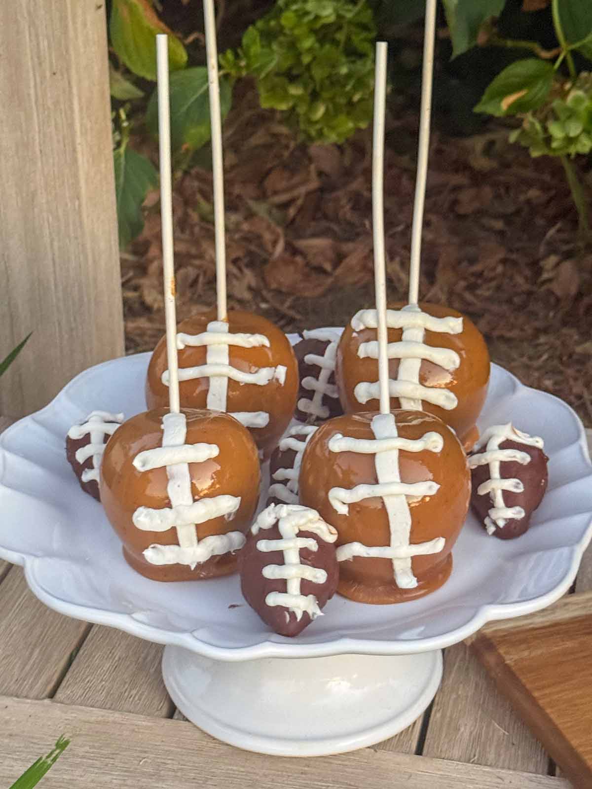 Entertaining expert, journalist and lifestyle blogger Candie Anderson of candieanderson.com shares the delicious homemade caramel apples and chocolate covered strawberries made to look like footballs on her white ceramic cake stand.