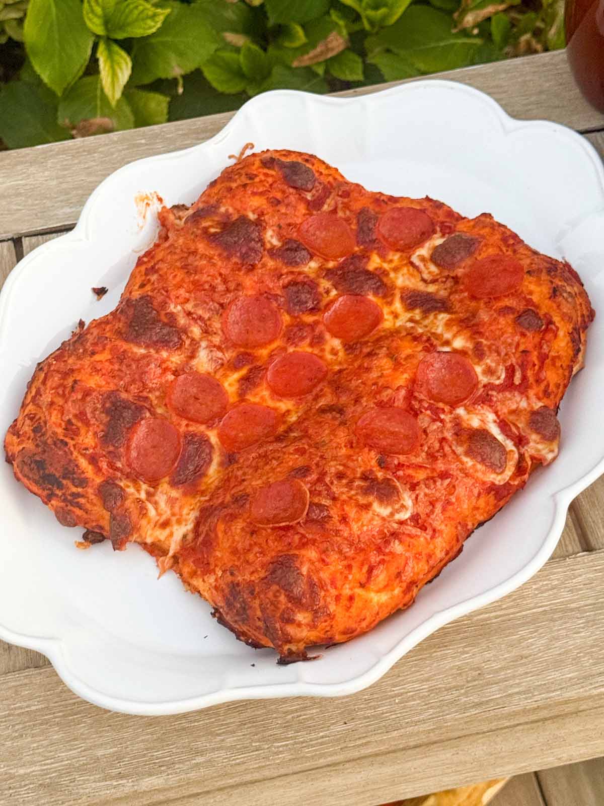 Entertaining expert, journalist and lifestyle blogger Candie Anderson of candieanderson.com shares the delicious homemade pepperoni pizza she made using her pizza stone in her induction oven. The pizza is perfect on a white platter.
