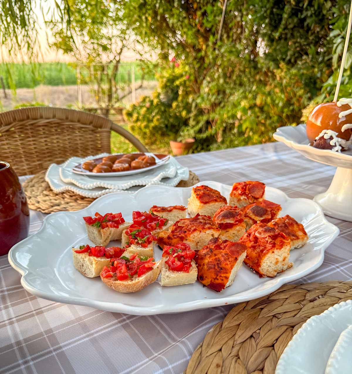 Entertaining expert, journalist and lifestyle blogger Candie Anderson of candieanderson.com shares the delicious pepperoni pizza and bruschetta she made and served on a white platter at her tailgate party.