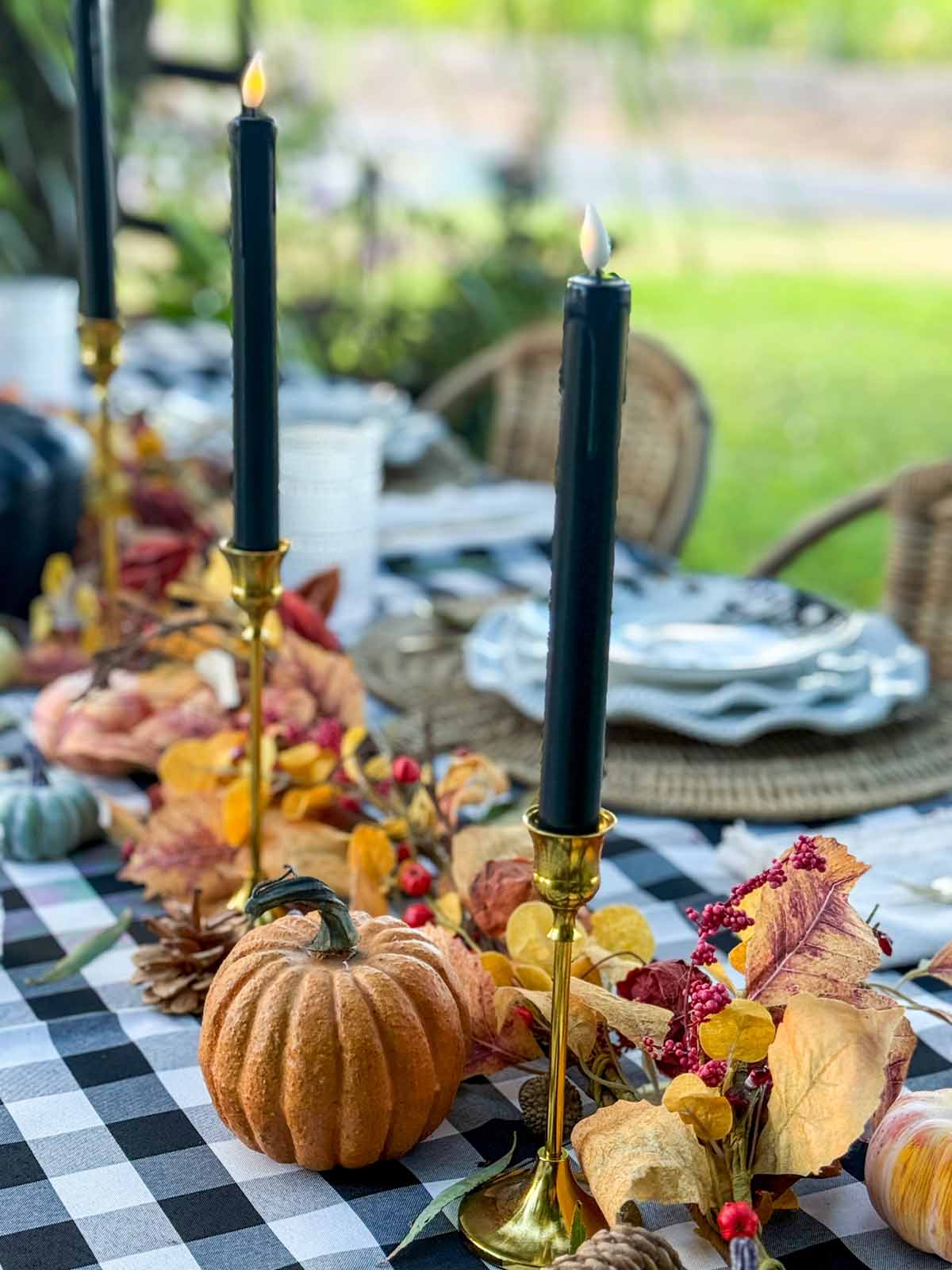 Entertaining expert, journalist and lifestyle blogger Candie Anderson of candieanderson.com shares how she adorned her Halloween tablescape with black taper candles.
