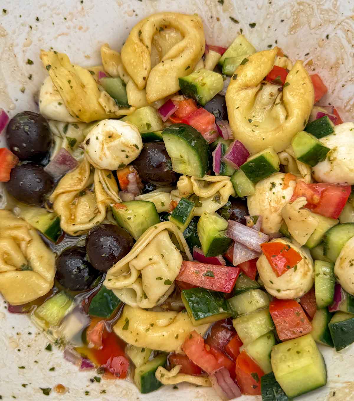 Entertaining expert, journalist and lifestyle blogger Candie Anderson of candieanderson.com shares the delicious homemade cheese tortellini salad she made for her Halloween party. She served it in an orange mixing bowl.