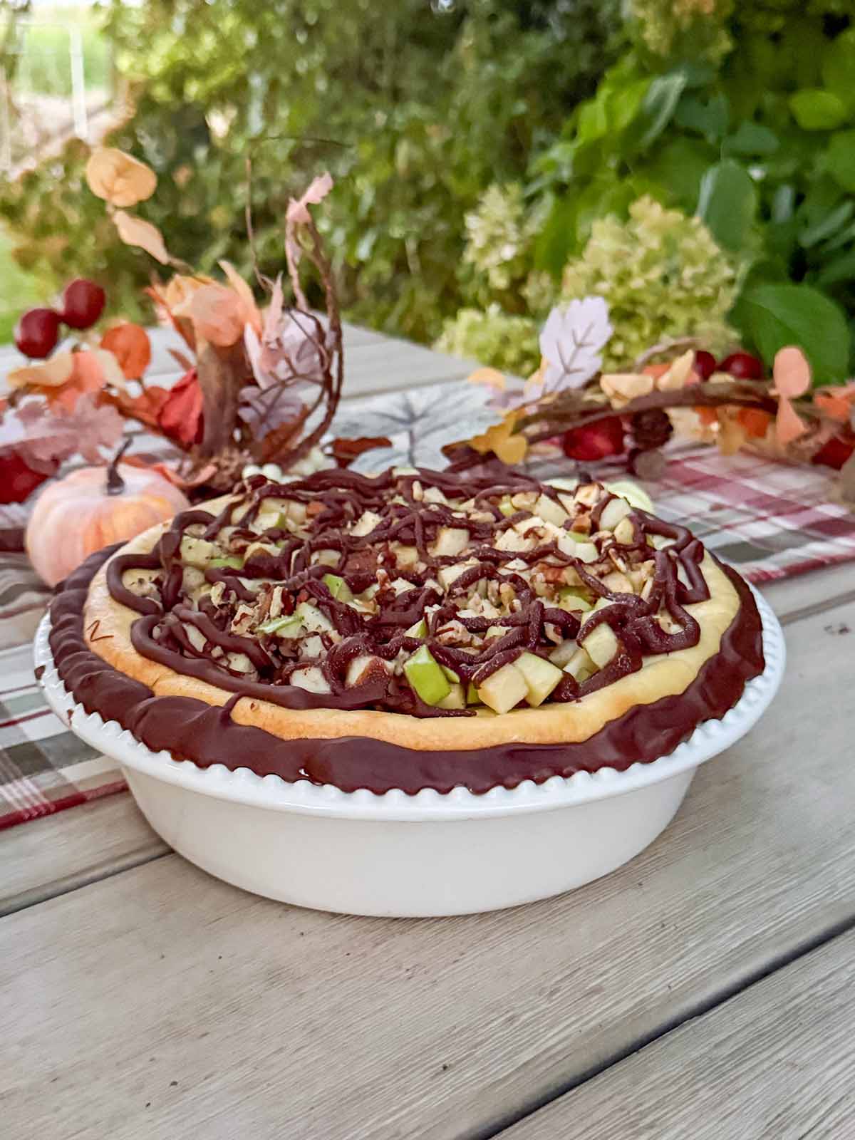 Entertaining expert, journalist and lifestyle blogger Candie Anderson of candieanderson.com shares her breautiful chocolate cheesecake adorned with Granny Smith apples and chopped pecans on her fall tablescape.
