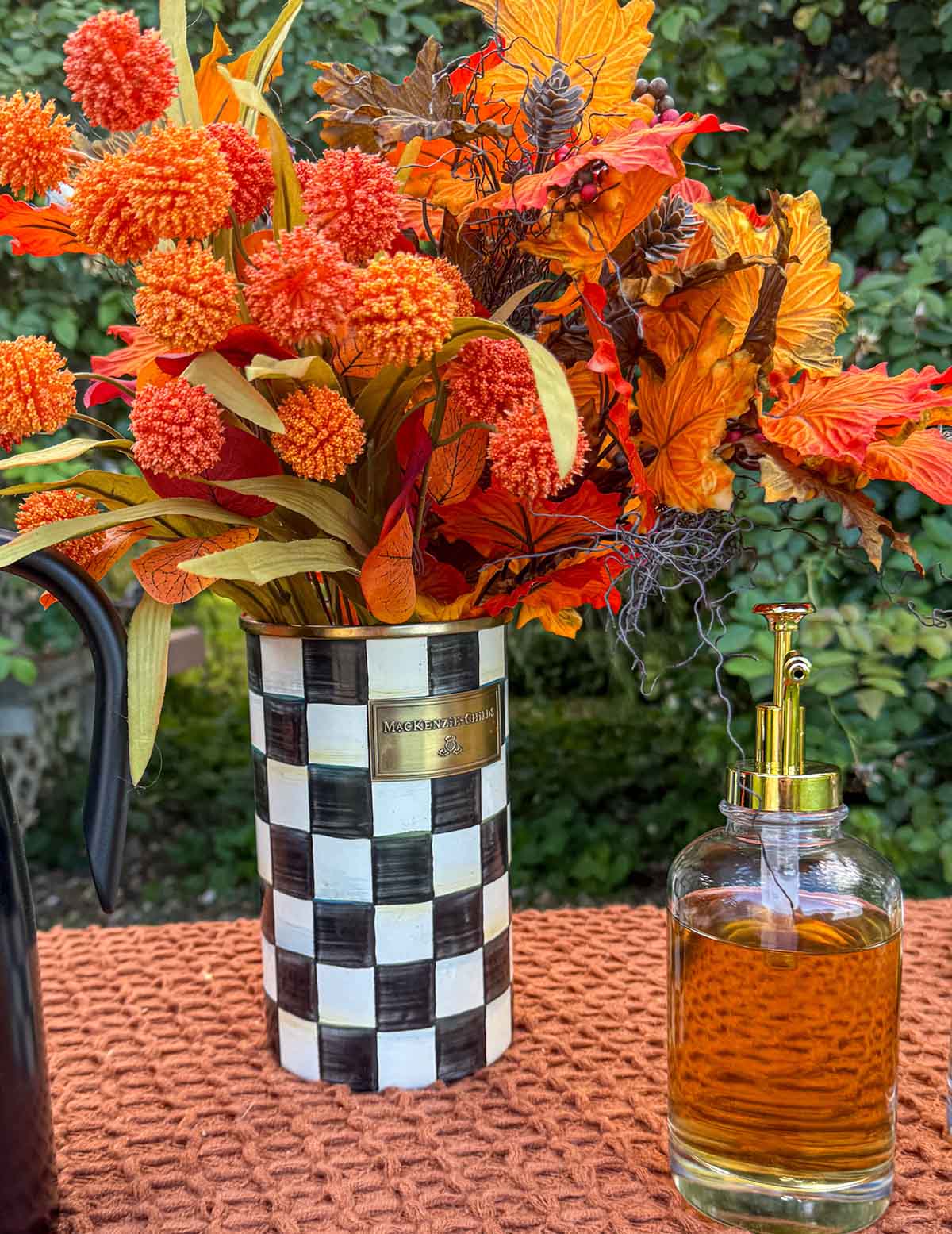 Entertaining expert, journalist and lifestyle blogger Candie Anderson of candieanderson.com shares her Mackenzie Childs Courtly Check Crock in black and white filled with fall foliage.