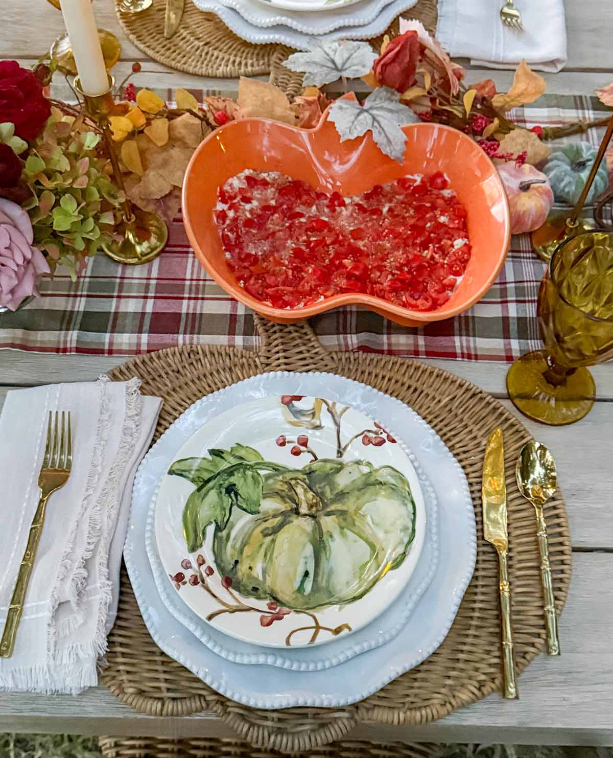 Entertaining expert, journalist and lifestyle blogger Candie Anderson of candieanderson.com shares her beautaiful fall plates on her white dinnerware and rattan pumpkin shaped placemats.