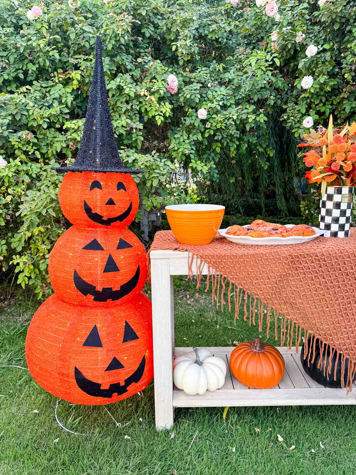Entertaining expert, journalist and lifestyle blogger Candie Anderson of candieanderson.com shows how she created her hosting station with a 5ft tall jackolantern as decor, orange mixing bowls,  a pumpkin shaped pizza, a courtly check crock used as a vase, caramel apples, tortellini and more.