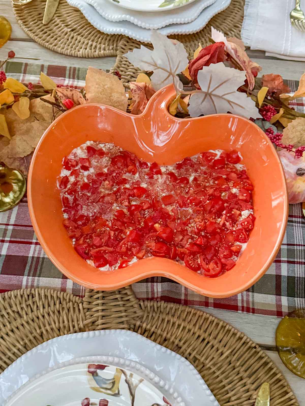 Entertaining expert, journalist and lifestyle blogger Candie Anderson of candieanderson.com shares the bruschetta dip she served in her pumpkin shaped platter on her heritage inspired fall tablescape. This is the perfect appetizer for Thanksgiving or any occasion!