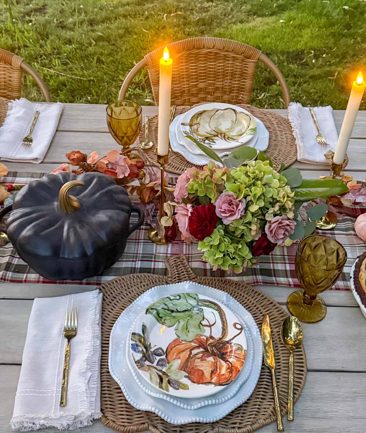 Entertaining expert, journalist and lifestyle blogger Candie Anderson of candieanderson.com set a beautiful heritage fall tablescape with rattan pumpkin shaped placemats, white dinnerware and fall inspired salad plates adorned with pumpkins.