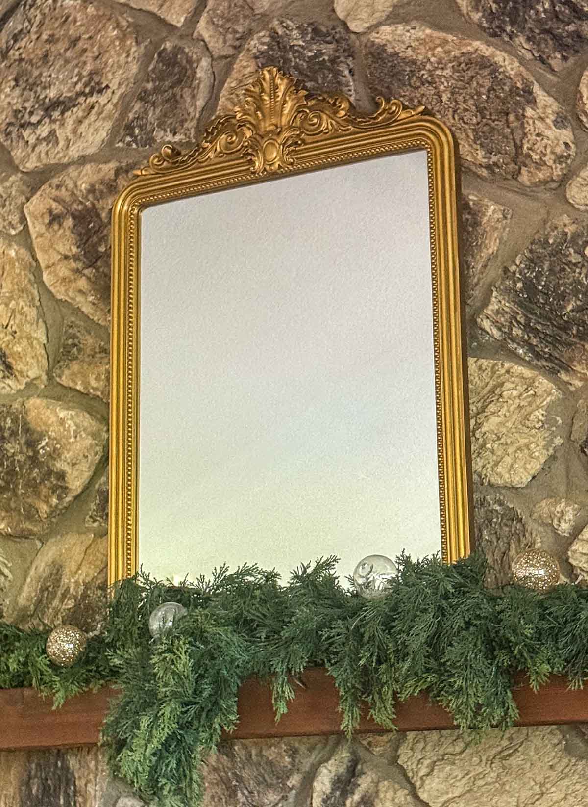 Entertaining expert, journalist and lifestyle blogger Candie Anderson of candieanderson.com shares the beautiful East Urban Design Baroque Vintage Mirror in gold on her classic Christmas fireplace mantel.