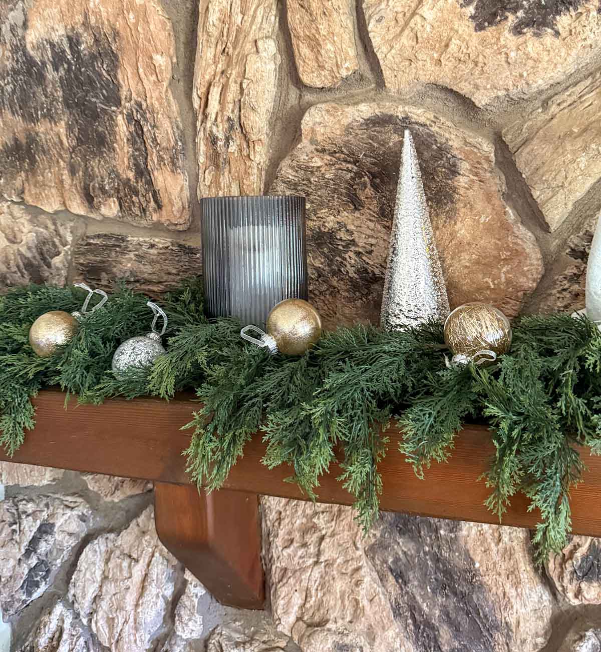 Entertaining expert, journalist and lifestyle blogger Candie Anderson of candieanderson.com shares how she decorated her fireplace mantel with ribbed glass candleholders, faux cedar garland, shatterproof Christmas ornaments, metallic Christmas trees and more.