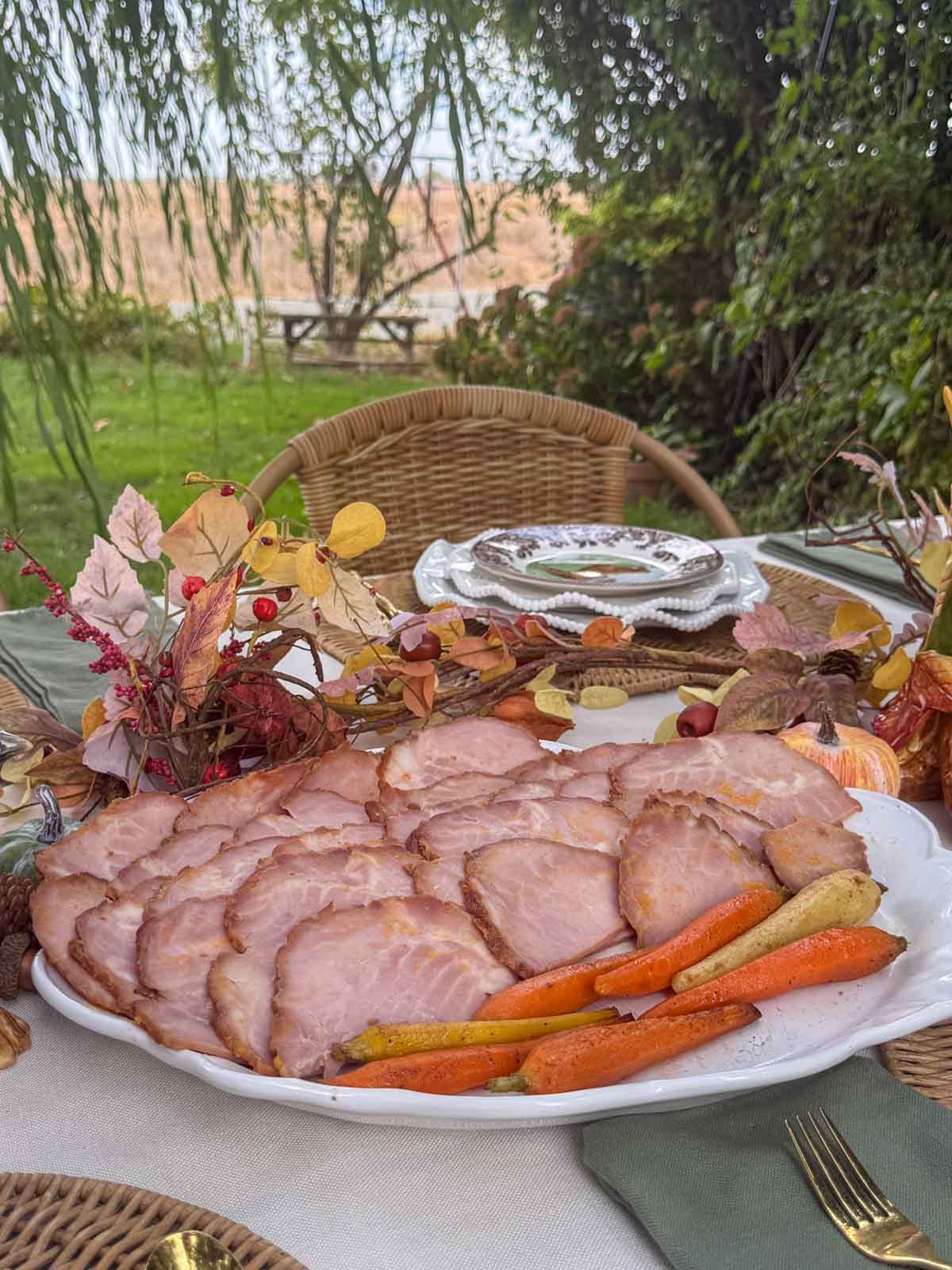 Entertaining expert, journalist and lifestyle blogger Candie Anderson of candieanderson.com shares the delicious ham she made for Thanksgiving and placed on a white serving platter on her tablescape.